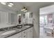 Bathroom featuring double sinks, granite counters, and access to an adjacent bedroom and closet at 1788 Hanover West Ct, Lawrenceville, GA 30043