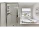 Bright bathroom with large soaking tub with window view and separate glass enclosed shower at 1788 Hanover West Ct, Lawrenceville, GA 30043