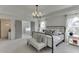 Open bedroom with tray ceiling, ample natural light, and sitting area near ensuite bathroom at 1788 Hanover West Ct, Lawrenceville, GA 30043