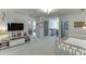 Large, carpeted bonus room with TV and adjacent sitting areas near a gated staircase at 1788 Hanover West Ct, Lawrenceville, GA 30043