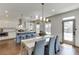 Bright kitchen featuring a blue island, stainless appliances, and an adjacent dining area with seating at 1788 Hanover West Ct, Lawrenceville, GA 30043