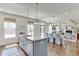 Open-concept kitchen showcasing a blue island and dining area with views into the living space at 1788 Hanover West Ct, Lawrenceville, GA 30043