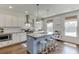 Updated kitchen with a blue island, granite countertops, stainless appliances, and designer lighting at 1788 Hanover West Ct, Lawrenceville, GA 30043