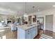 Bright kitchen features a blue island with granite countertops, stainless appliances, and modern lighting at 1788 Hanover West Ct, Lawrenceville, GA 30043