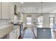 Modern kitchen with stainless appliances, subway tile backsplash, island, and stylish range hood at 1788 Hanover West Ct, Lawrenceville, GA 30043