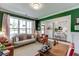 Comfortable living area with green accent wall, hardwood floors, and designer furnishings at 1788 Hanover West Ct, Lawrenceville, GA 30043