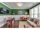 Cozy living room with a large window, green walls, wainscotting, and designer decor at 1788 Hanover West Ct, Lawrenceville, GA 30043