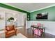 Inviting living space featuring green walls, hardwood flooring, and stylish furnishings at 1788 Hanover West Ct, Lawrenceville, GA 30043