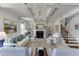 Bright living room with coffered ceilings, fireplace, comfortable seating, and adjacent staircase access at 1788 Hanover West Ct, Lawrenceville, GA 30043