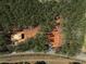 A home under construction from an aerial perspective, highlighting the surrounding landscape and road access at 3240 Miller Bottom Rd, Conyers, GA 30012