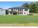 Large backyard features a white brick house, covered porch, and well-maintained landscaping at 3240 Miller Bottom Rd, Conyers, GA 30012