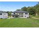 Beautiful view of the house from the backyard with a large lawn at 3240 Miller Bottom Rd, Conyers, GA 30012