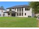 Expansive backyard showcasing the home's exterior, a covered patio, and well-maintained landscaping at 3240 Miller Bottom Rd, Conyers, GA 30012
