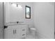 Well-lit half bathroom featuring a floating vanity with marble countertop and modern fixtures at 3240 Miller Bottom Rd, Conyers, GA 30012