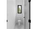 Modern bathroom with a narrow window, white walls, toilet, and elegant marble tile flooring at 3240 Miller Bottom Rd, Conyers, GA 30012