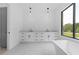Modern bathroom featuring a double vanity, sleek pendants, and a large window for natural light at 3240 Miller Bottom Rd, Conyers, GA 30012