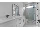 Modern bathroom with double vanity, glass enclosed shower, and sleek black hardware at 3240 Miller Bottom Rd, Conyers, GA 30012