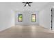 Bright bedroom featuring a modern ceiling fan, and two large windows offering ample natural light at 3240 Miller Bottom Rd, Conyers, GA 30012