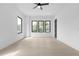 Spacious bedroom featuring wood flooring, ceiling fan, and windows with natural light at 3240 Miller Bottom Rd, Conyers, GA 30012