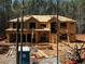 Exterior view of new home construction featuring exposed wood framing and sheathing at 3240 Miller Bottom Rd, Conyers, GA 30012