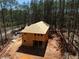Two-story home under construction with a wooded lot, showcasing the framing and initial roof work at 3240 Miller Bottom Rd, Conyers, GA 30012