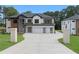 Modern home featuring a multi-car garage, brick accents, complemented by a well-manicured lawn and contemporary design elements at 3240 Miller Bottom Rd, Conyers, GA 30012