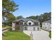 Stunning new construction home with a modern design, three-car garage and lush landscaping at 3240 Miller Bottom Rd, Conyers, GA 30012