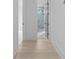 Bright hallway showcases wood flooring and an open view to a bathroom at 3240 Miller Bottom Rd, Conyers, GA 30012