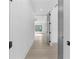 Hallway with light wood floors, neutral walls, and views to a sunlit living area at 3240 Miller Bottom Rd, Conyers, GA 30012