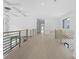 Spacious hallway featuring modern lighting, wood floors, and minimalist black metal railings at 3240 Miller Bottom Rd, Conyers, GA 30012