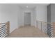 Second story hallway with sleek black metal railings, bright white walls and light wood floors at 3240 Miller Bottom Rd, Conyers, GA 30012