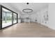 Open-concept kitchen featuring an island, all-white cabinetry, modern light fixture, and sliding doors at 3240 Miller Bottom Rd, Conyers, GA 30012