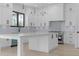 Bright, white kitchen with a large island, modern appliances, and pendant lighting at 3240 Miller Bottom Rd, Conyers, GA 30012