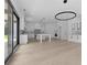 Open concept kitchen with white cabinets, stainless appliances, granite countertops and modern lighting at 3240 Miller Bottom Rd, Conyers, GA 30012
