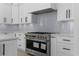 Modern kitchen featuring stainless steel appliances, white cabinetry, and subway tile backsplash at 3240 Miller Bottom Rd, Conyers, GA 30012