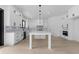 Well-lit kitchen with white cabinetry, stainless steel appliances, and an island with marble countertop at 3240 Miller Bottom Rd, Conyers, GA 30012