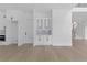 Open living area with white cabinets, granite countertops, and stainless steel oven at 3240 Miller Bottom Rd, Conyers, GA 30012