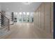 Spacious living room featuring large windows, sleek fireplace with shelving, and light hardwood flooring at 3240 Miller Bottom Rd, Conyers, GA 30012