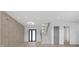 Stylish living room showcasing decorative wall paneling, a modern ceiling fan, and staircase access for a sophisticated design at 3240 Miller Bottom Rd, Conyers, GA 30012