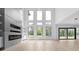 Bright living room featuring floor-to-ceiling windows, contemporary fireplace and shelving, plus light hardwood flooring at 3240 Miller Bottom Rd, Conyers, GA 30012