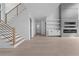 Bright, open-concept space featuring a staircase, modern fireplace, and light wood flooring, creating a welcoming atmosphere at 3240 Miller Bottom Rd, Conyers, GA 30012
