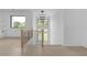 Upstairs loft area featuring modern railing, recessed lighting, and a large window offering picturesque outdoor views at 3240 Miller Bottom Rd, Conyers, GA 30012