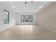 Spacious main bedroom boasting natural light, decorative wall paneling, and a ceiling fan for a comfortable living space at 3240 Miller Bottom Rd, Conyers, GA 30012