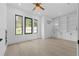 Bright office space with modern ceiling fan, large windows, and custom built-in shelving and cabinets at 3240 Miller Bottom Rd, Conyers, GA 30012