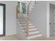 Staircase with wood treads and black metal railings, complemented by natural light streaming through a nearby window at 3240 Miller Bottom Rd, Conyers, GA 30012