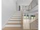 Modern staircase with light wood treads, white risers, and sleek black metal railing accents, showcasing a bright, open entryway at 3240 Miller Bottom Rd, Conyers, GA 30012