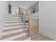 Staircase with hardwood treads, white risers, and black metal railing at 3240 Miller Bottom Rd, Conyers, GA 30012