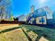 View of the home's exterior and backyard featuring a spacious lawn and outdoor seating area at 4962 Newpark Nw Ln, Acworth, GA 30101