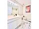 Well-lit bathroom with modern vanity, decorative mirror, and tiled floors at 4962 Newpark Nw Ln, Acworth, GA 30101