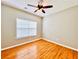This bedroom features hardwood floors, a ceiling fan, and a window for natural light at 4962 Newpark Nw Ln, Acworth, GA 30101